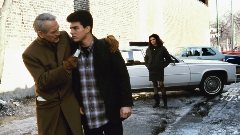 Paul Newman handing Tom Cruise money