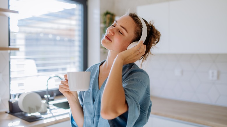 person wearing headphones in kitchen