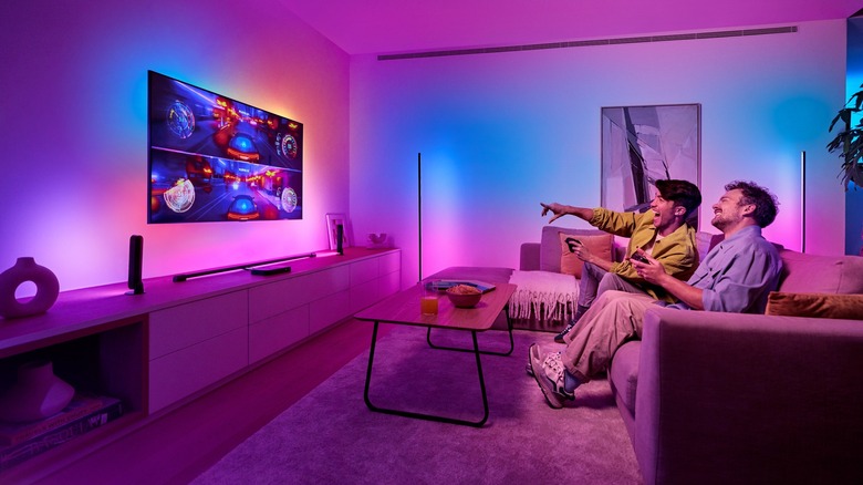 People watching TV with Philips Hue Play HDMI Sync Box connected