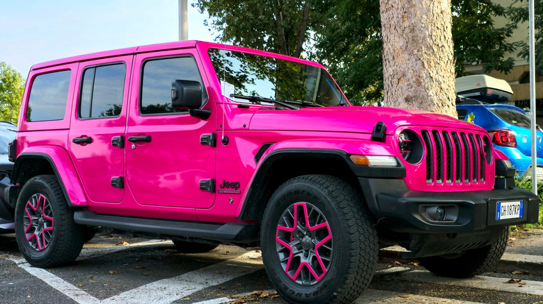 Pink Jeep Wrangler on road