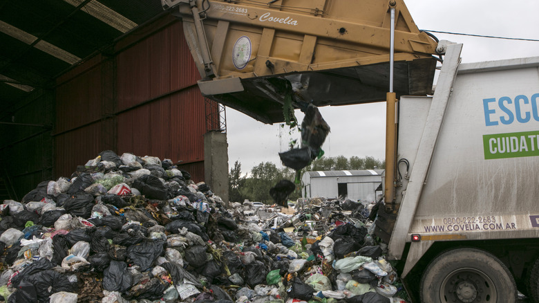 truck unloading heaps of waste