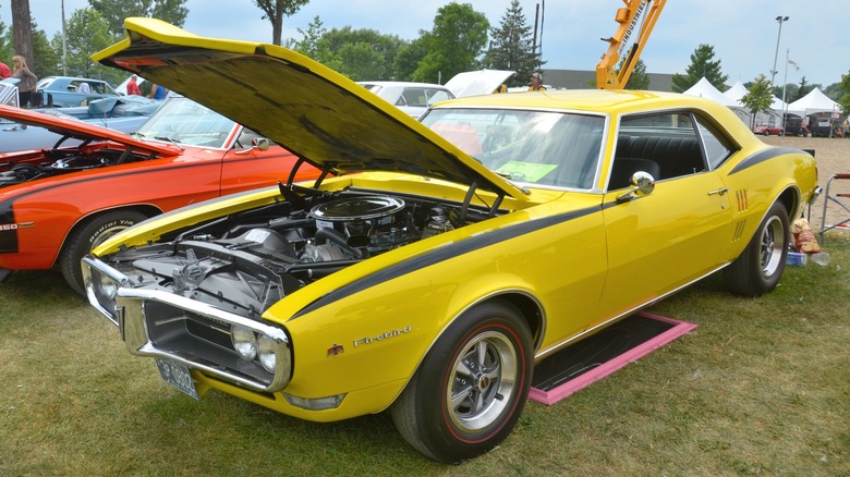 Yellow 1967 Pontiac Firebird parked on grass