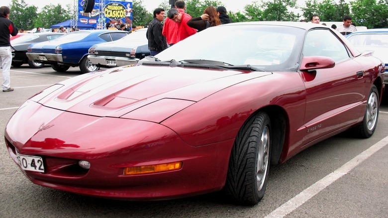 Red 1994 Pontiac Firebird parked