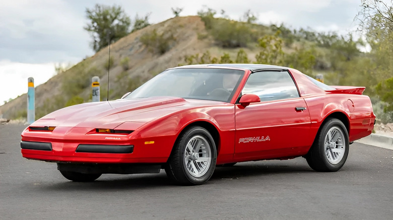 Red 1989 Pontiac Firebird parked