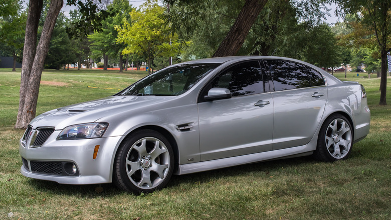 Silver Pontiac G8 parked on grass