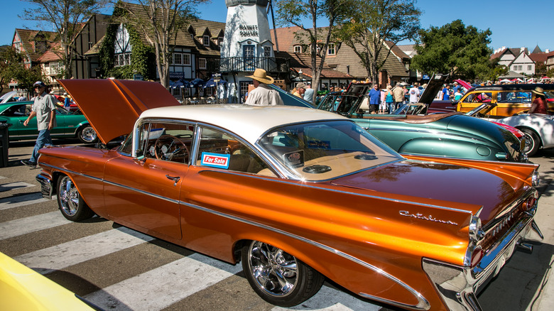 A Pontiac Catalina hard top in orange at a car show