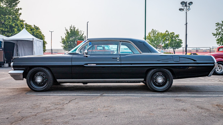 A Pontiac Grand Prix hard top in a parking space