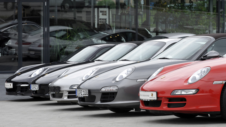 A row of Porsche 911s at a dealership