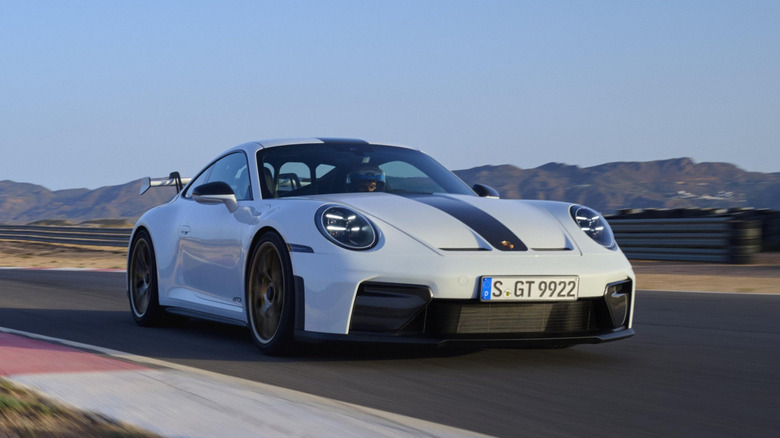 Porsche 992 GT3 front-end view driving on track