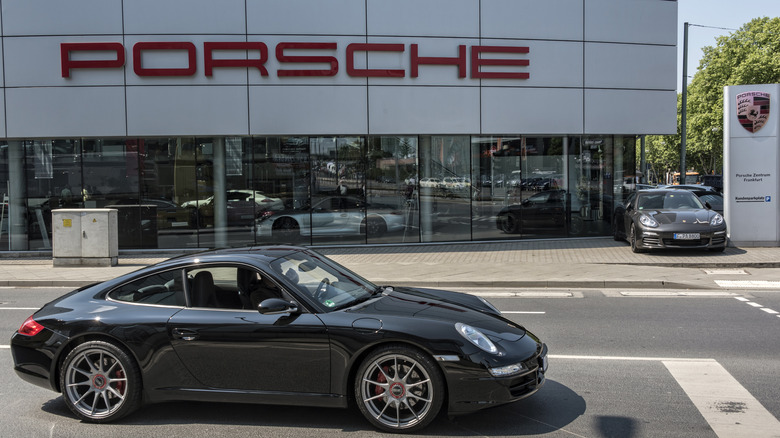 porsche in front of dealership