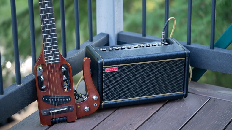 Positive Grid Spark 2 Amp next to a guitar.