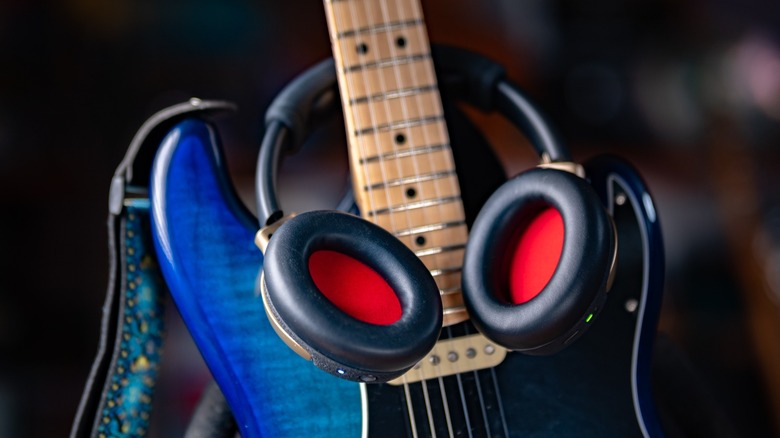 The Spark Neo around the neck of a blue Fender Stratocaster.