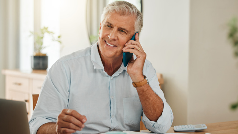 older man on smartphone call