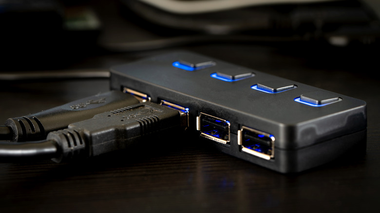 Close up of a USB hub with cables connected on a desk