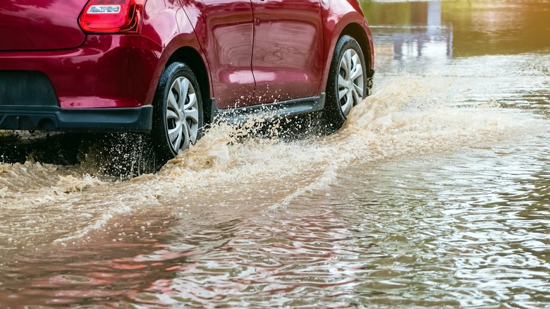 Car driving in flood waters