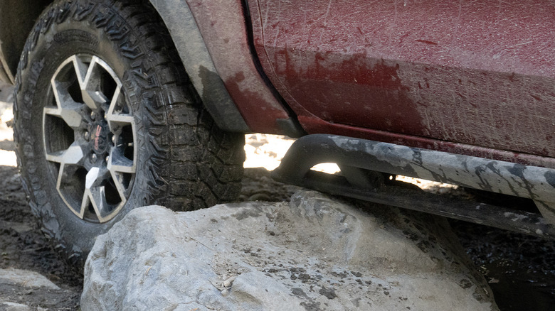 GMC Canyon AT4X sliding on a rock