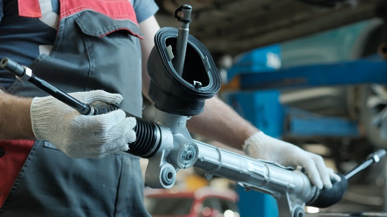 mechanic holding rack and pinion