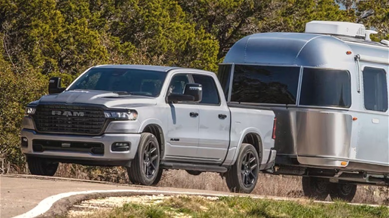 Silver 2025 Ram 1500 towing camping trailer