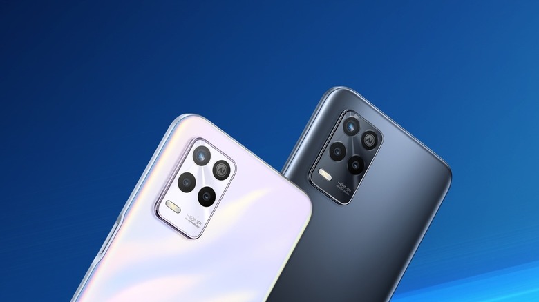 The Realme 9 smartphones in black, and white color options.