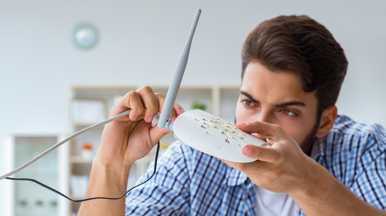 Man connecting a cable into the router