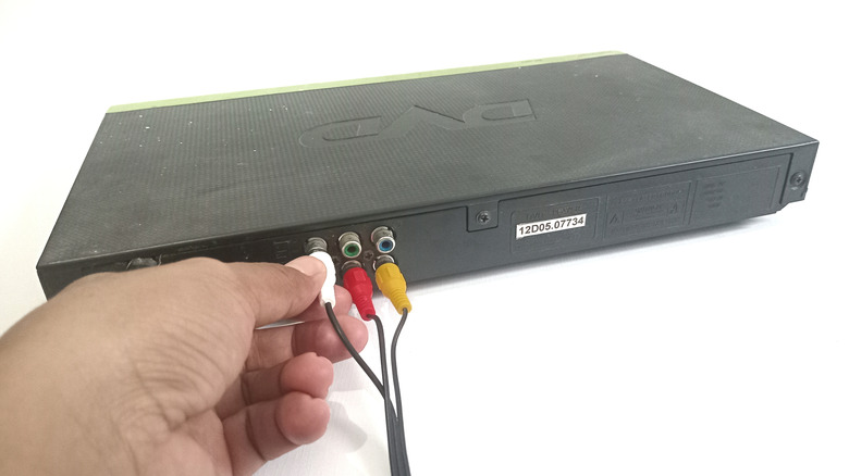 Person plugging RCA connectors into a device