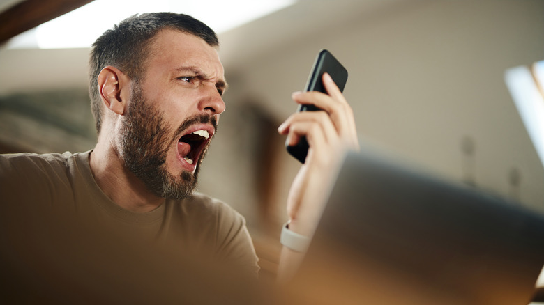 man yelling at his smartphone