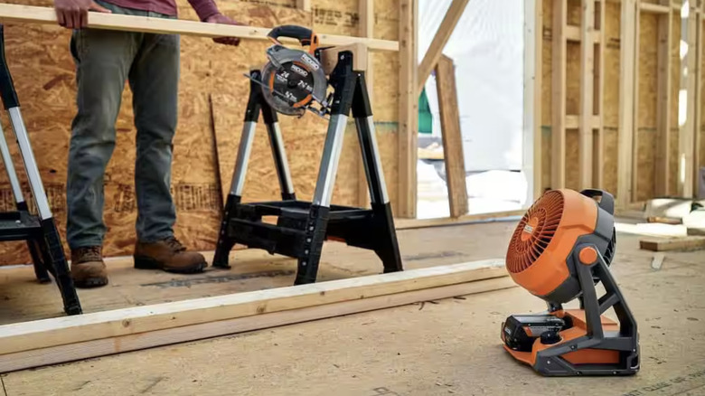 orange and black fan sitting on floor