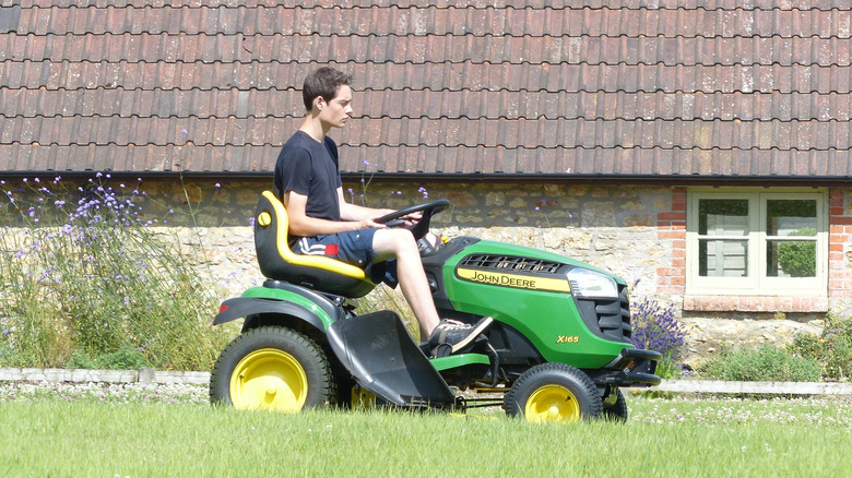 Man on John Deere riding mower