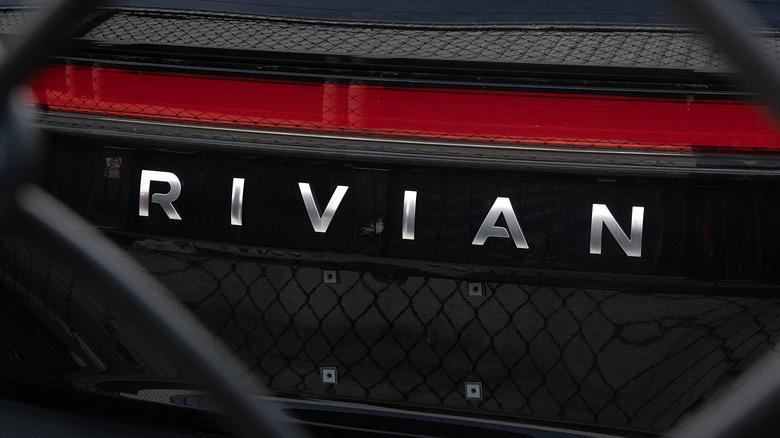 The rear of a Rivian SUV with a prominent Rivian logo