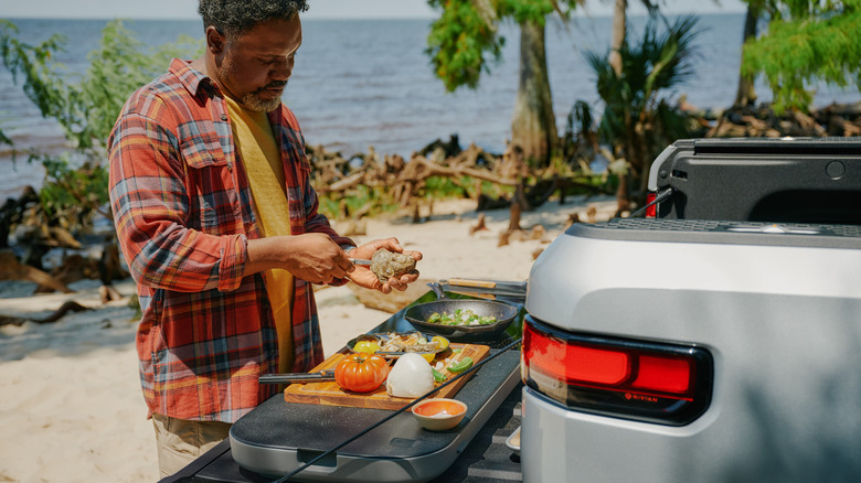 Person cooking on Rivian Travel Kitchen