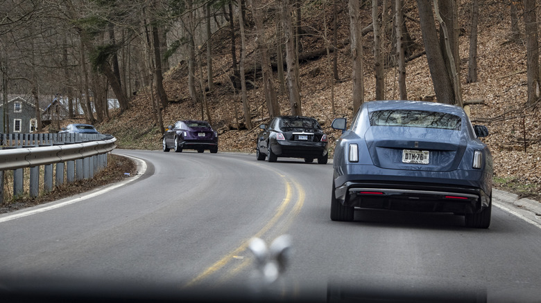 Rolls Royces driving in a convoy