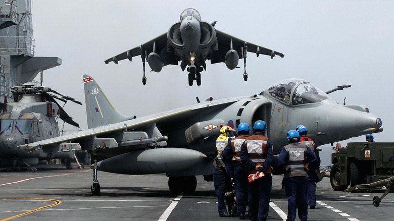 Harrier jet landing on an aircraft carrier