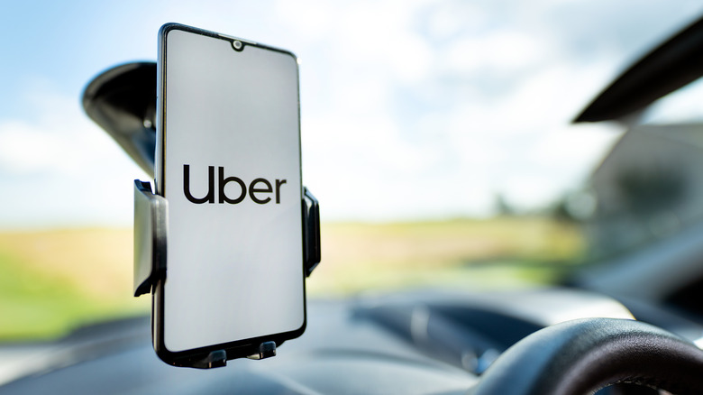 Uber app on phone attached to windshield