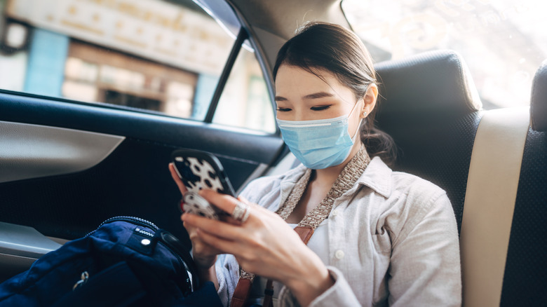 Well-dressed woman in the back of a rideshare car