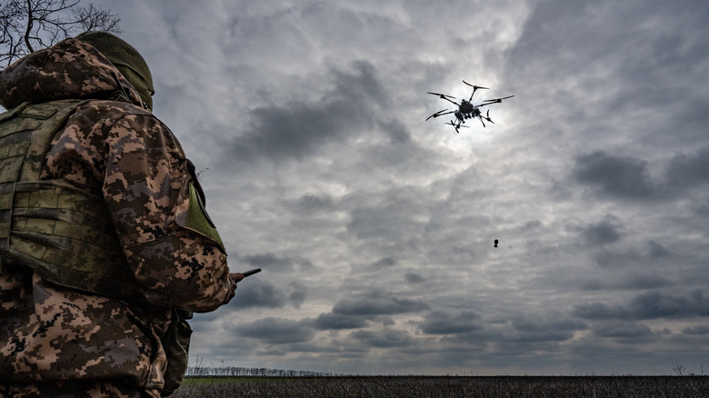 Ukrainian soldier flying an attack drone