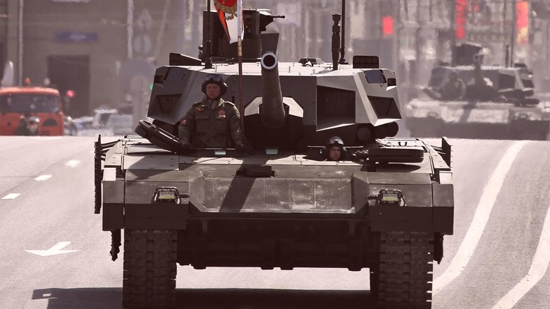 A T-14 Armata Main Battle Tank cruising down a paved road inside a city