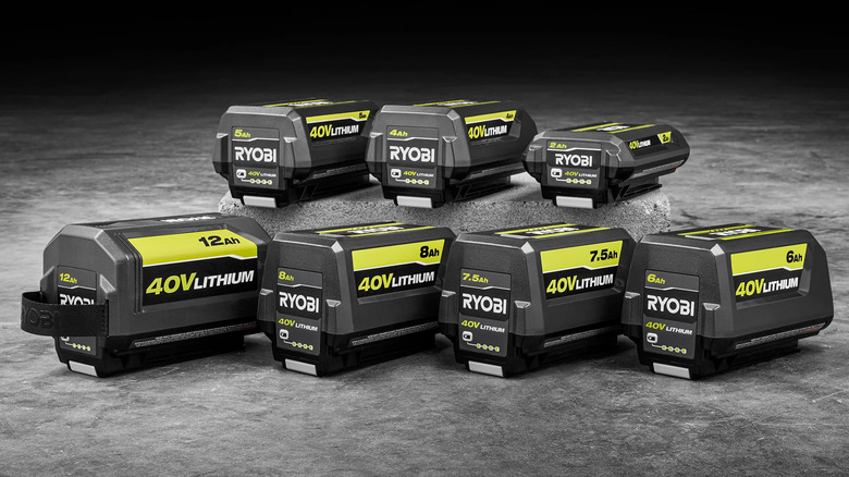 Seven 40V Ryobi batteries of varying sizes lined up on grey background