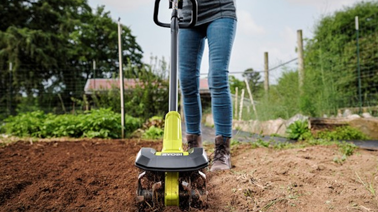 person using ryobi 8" Cordless Cultivator