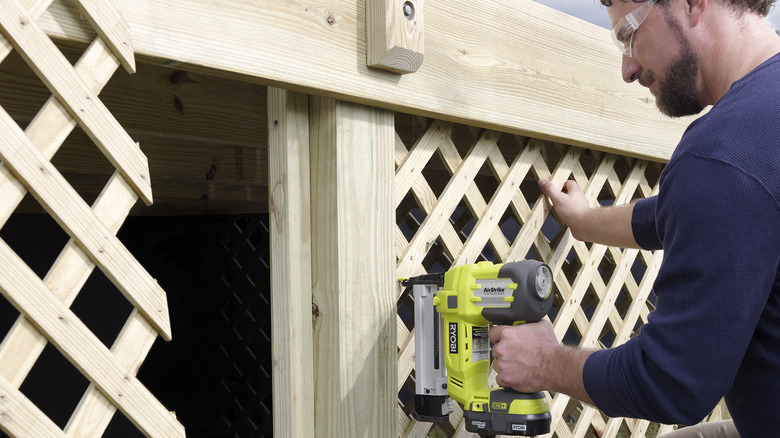 Man uses a Ryobi staple gun