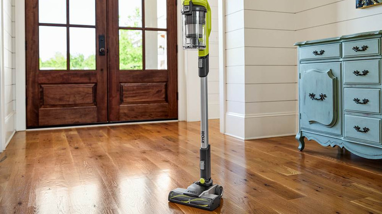 stick vacuum standing on hard wood