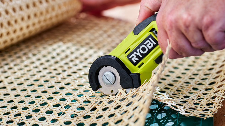 person using ryobi power cutter