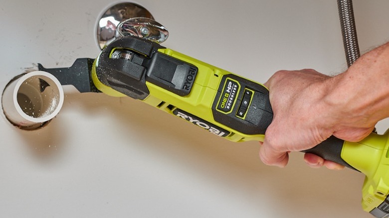 Person using Ryobi oscillating tool on PVC