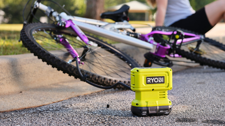 A tire inflator being used to inflate a bicycle tire