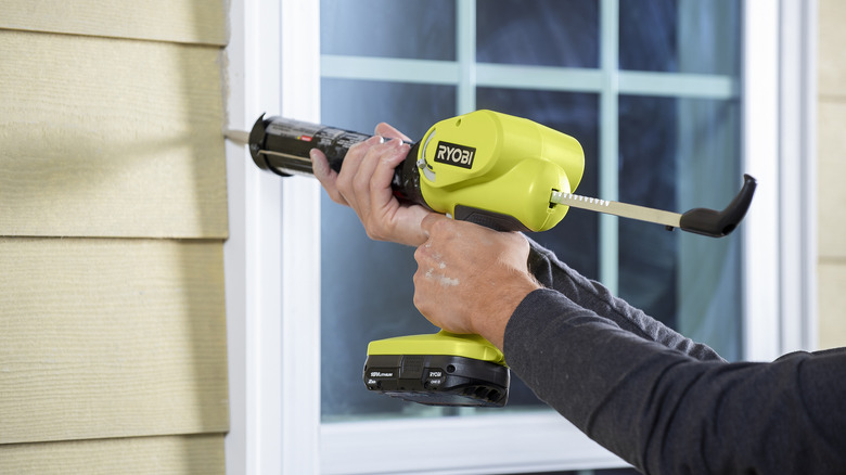 using Ryobi caulk gun on window sill outside