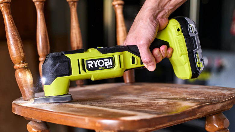 Ryobi 18V ONE+ HP Brushless Oscillating Multi-Tool sanding a chair