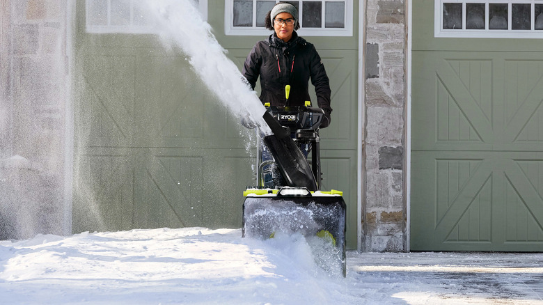 Individual clearing snow out of their driveway