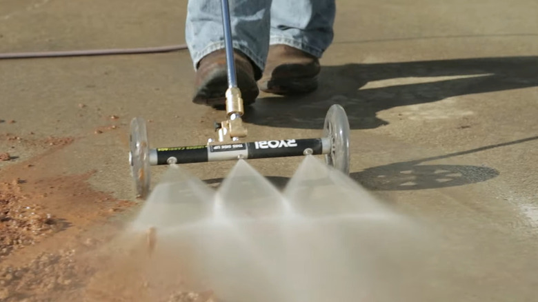 Water broom washing driveway