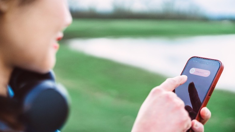 Woman shutting down an iPhone