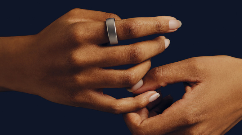 woman's hands wearing oura ring