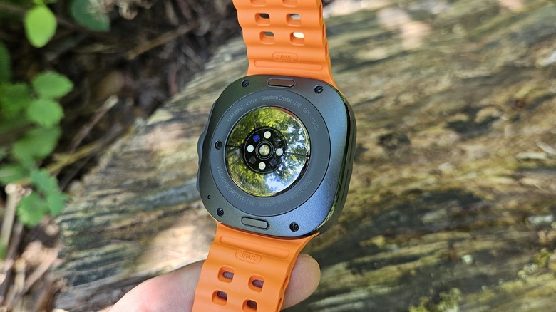 Samsung Galaxy Watch Ultra showing the BioActive Sensor with a log in the background.